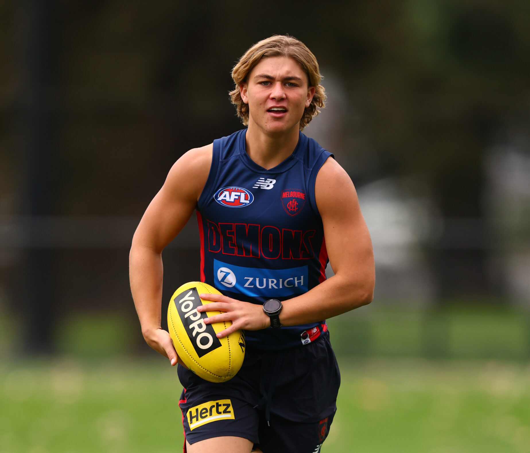 MELBOURNE, AUSTRALIA - APRIL 15: Thomas Matthews of the Demons runs with the ball during a Melbourne Demons AFL training session at Gosch's Paddock on April 15, 2026 in Melbourne, Australia. (Photo by Robert Cianflone/Getty Images)