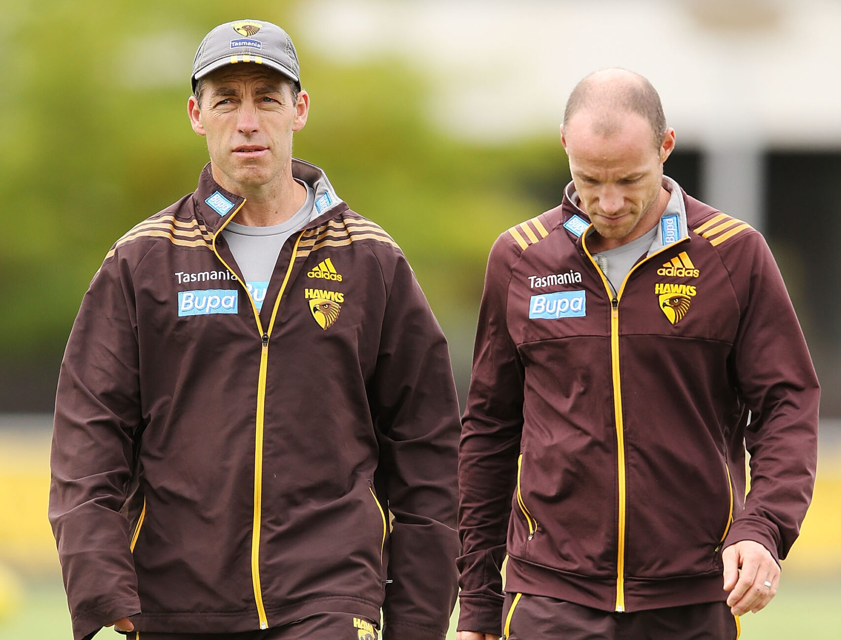 MELBOURNE, AUSTRALIA - MARCH 17: Hawks coach Alastair Clarkson (L) looks ahead next to Head Fitness Coach Andrew Russell during a Hawthorn Hawks AFL training session at Waverley Park on March 17, 2014 in Melbourne, Australia. (Photo by Michael Dodge/Getty Images)